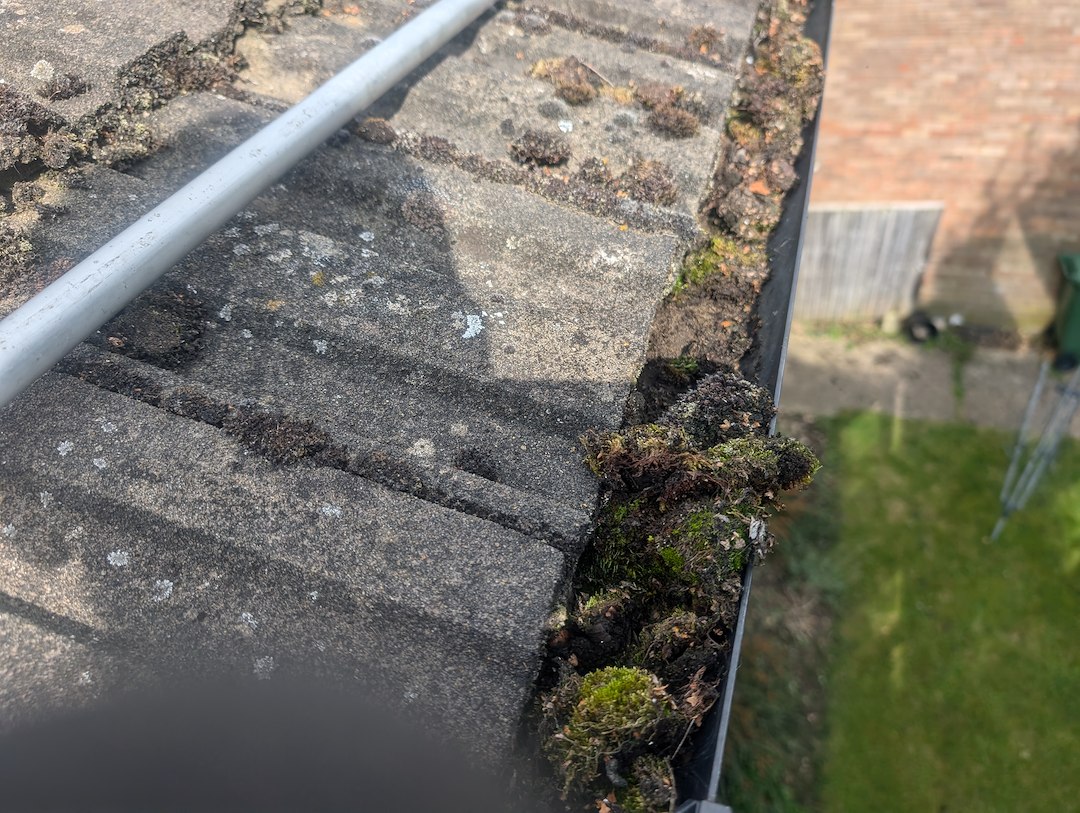 Gutters on a Henley-on-Thames home being vacuum-cleared of moss and debris