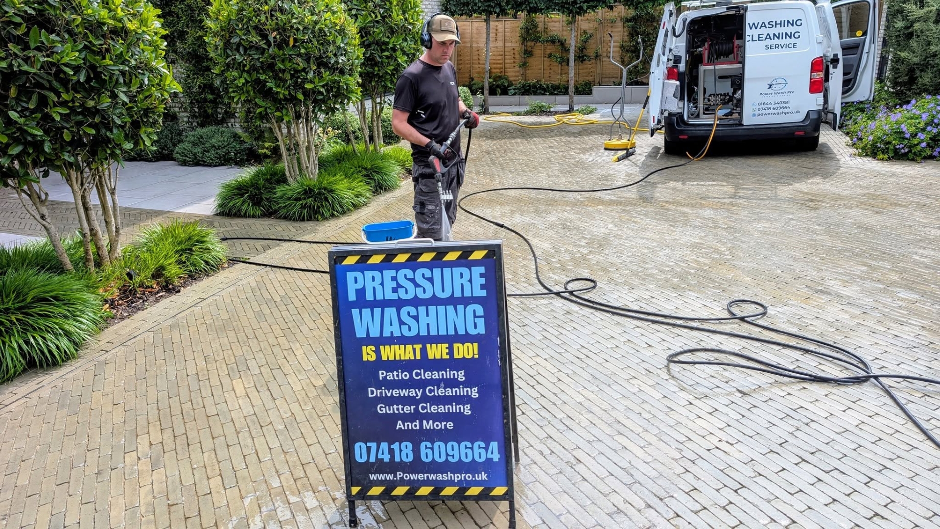 Andrew of Power Wash Pro performing a driveway pressure washing service